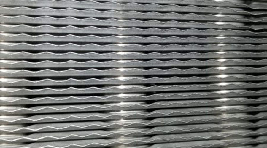 Steam coil with layered fins, illustrating HVAC system components for effective cleaning and maintenance, relevant to Steira Air's steam coil cleaning services.